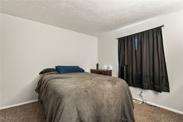 carpeted bedroom featuring a textured ceiling