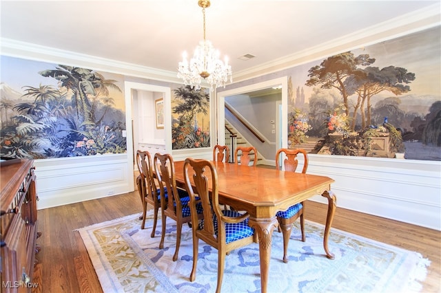 dining space featuring dark hardwood / wood-style flooring, a chandelier, and crown molding