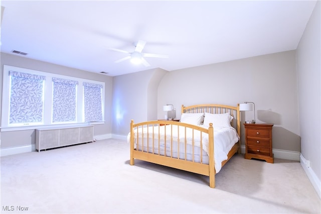 carpeted bedroom featuring radiator and ceiling fan