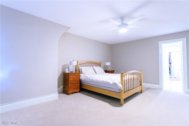 carpeted bedroom featuring ensuite bathroom and ceiling fan