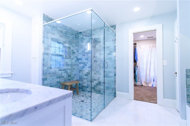 bathroom with walk in shower and vanity