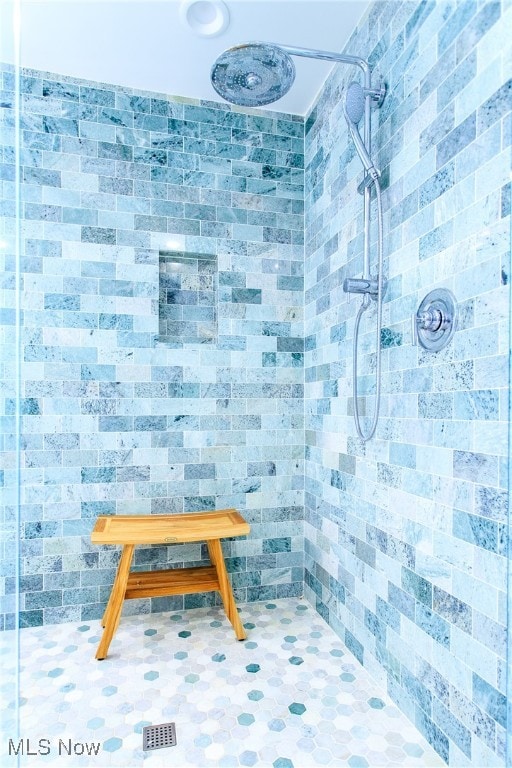 bathroom with tiled shower