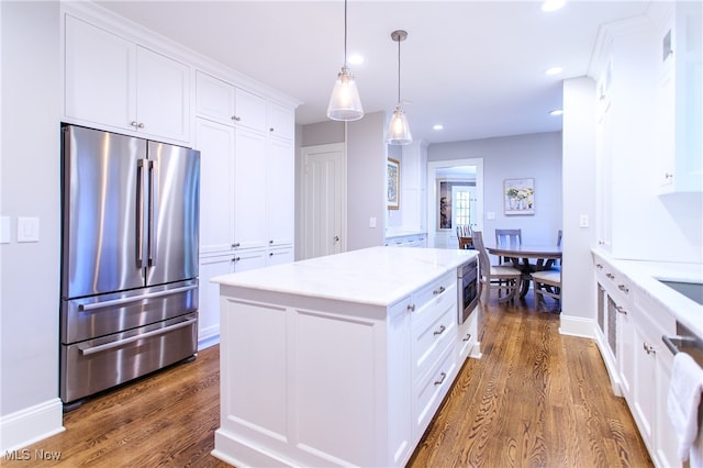 kitchen with white cabinetry, stainless steel appliances, and dark hardwood / wood-style floors