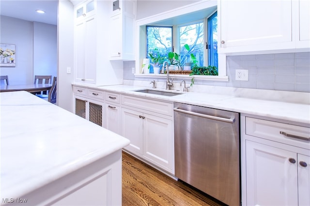 kitchen with stainless steel dishwasher, sink, light hardwood / wood-style floors, and white cabinets