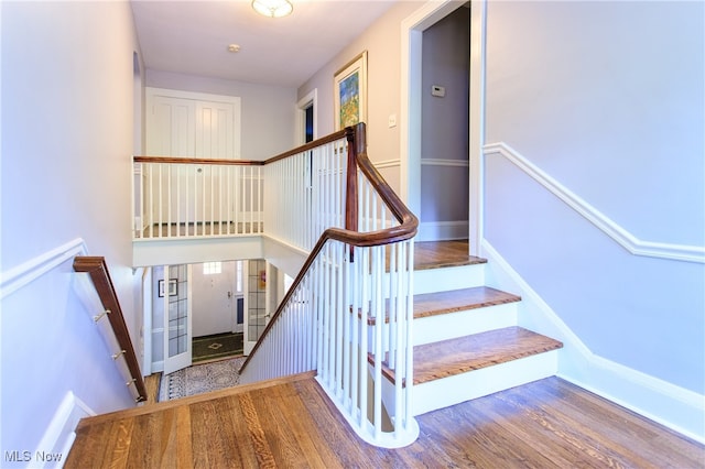 stairs with wood-type flooring