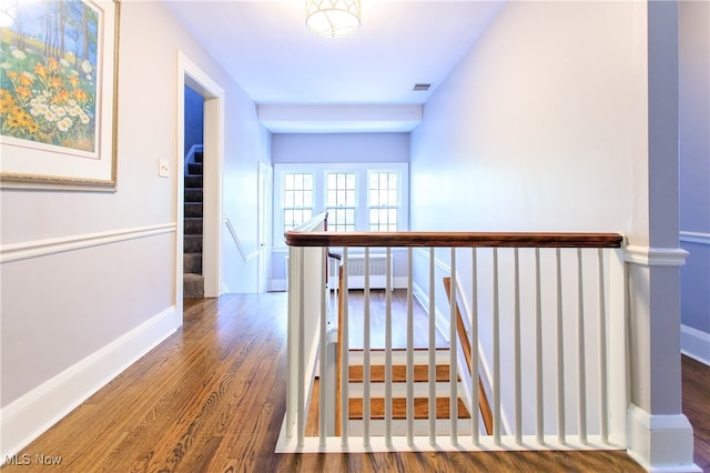 corridor with dark hardwood / wood-style floors