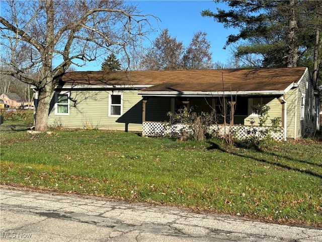 ranch-style home with a front lawn