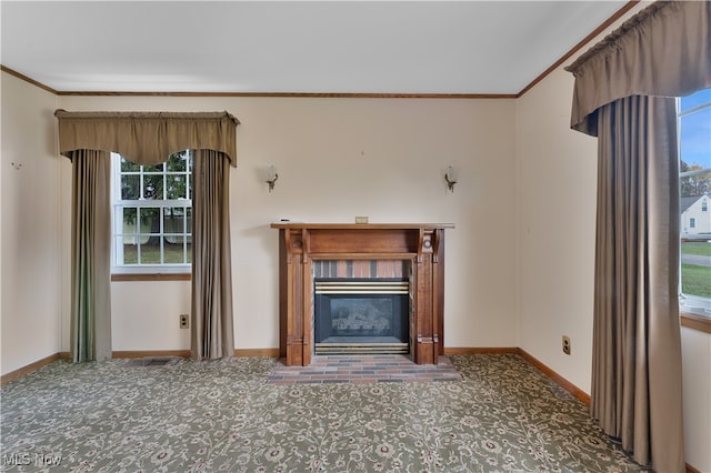 unfurnished living room with a wealth of natural light, dark carpet, and ornamental molding