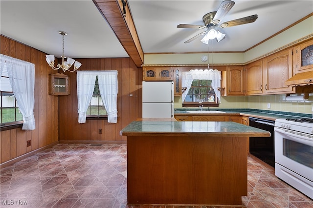 kitchen featuring plenty of natural light, white appliances, and a kitchen island