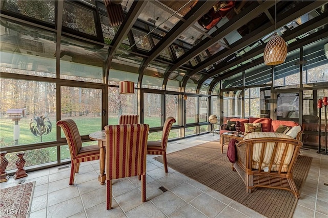 sunroom featuring plenty of natural light and lofted ceiling