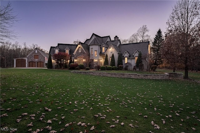 view of front of property featuring a lawn and a garage