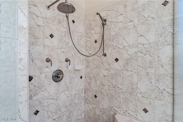 interior details featuring a tile shower