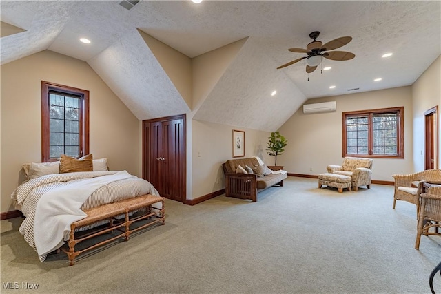 bedroom with a wall mounted air conditioner, vaulted ceiling, ceiling fan, a textured ceiling, and multiple windows