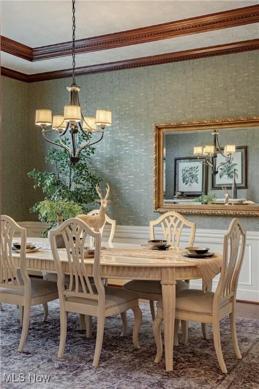 dining area featuring a chandelier and crown molding