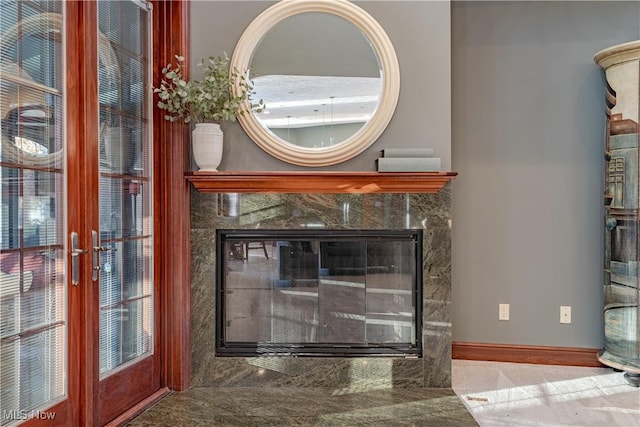 room details featuring a high end fireplace and french doors