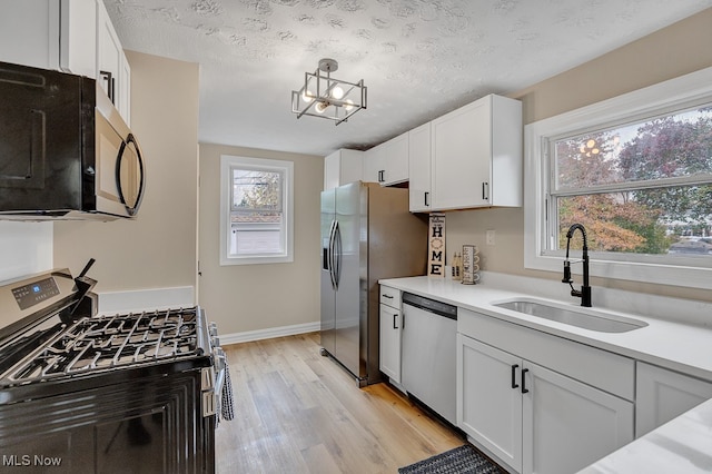 kitchen with white cabinetry, sink, a textured ceiling, and appliances with stainless steel finishes