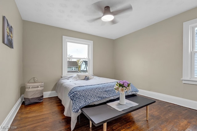 bedroom with ceiling fan and dark hardwood / wood-style floors