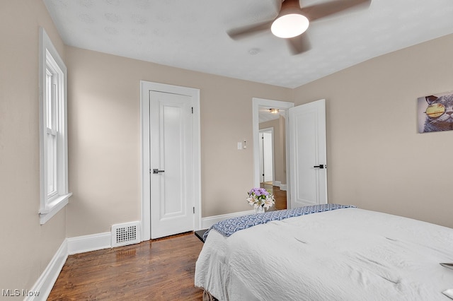 bedroom featuring a textured ceiling, ceiling fan, and dark hardwood / wood-style floors