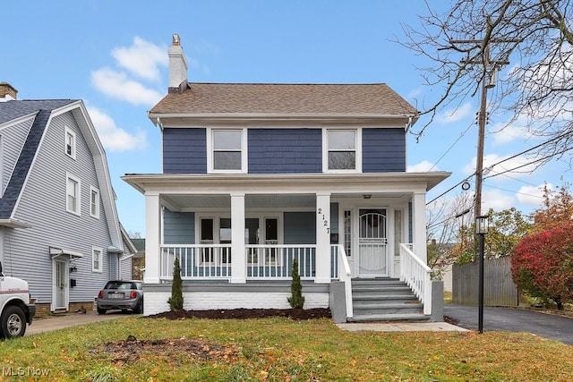 view of front of home with a porch and a front yard