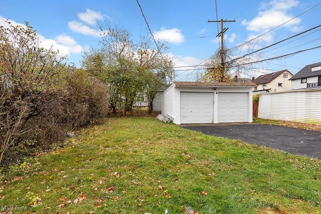 view of yard with a garage and an outdoor structure