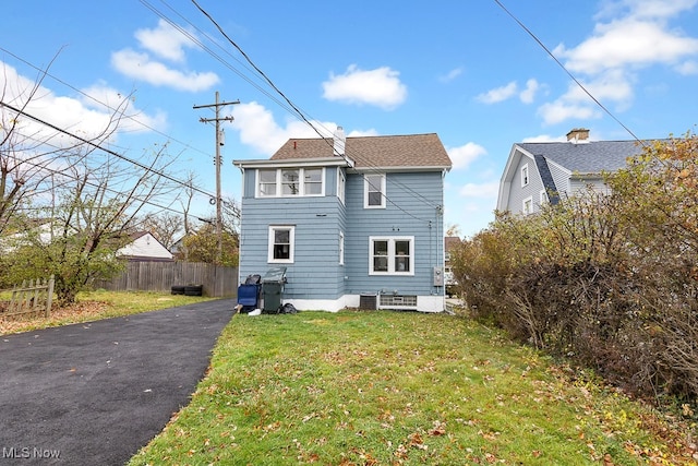 back of property featuring a lawn