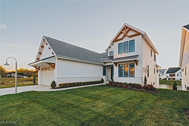S/L1 Bridgeport Way, Mayfield Heights, OH 44124 - view of front of house with a standing seam roof, a front lawn, a metal roof, concrete driveway, and stone siding