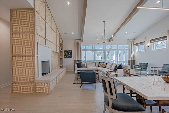 S/L1 Bridgeport Way, Mayfield Heights, OH 44124 - dining space featuring light wood finished floors, a chandelier, a tiled fireplace, recessed lighting, and built in shelves