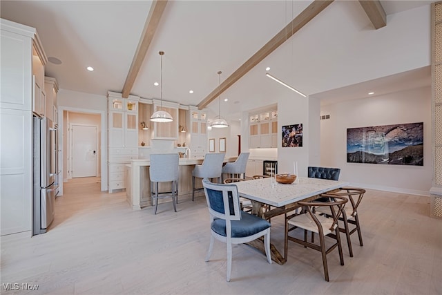 dining space featuring high vaulted ceiling, light hardwood / wood-style floors, and beamed ceiling