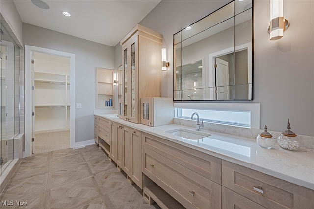 bathroom featuring vanity and a shower with shower door