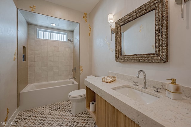 full bathroom with tile patterned flooring, tiled shower / bath, toilet, and vanity