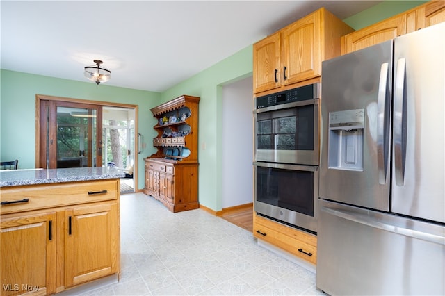 kitchen with stainless steel appliances and light stone countertops