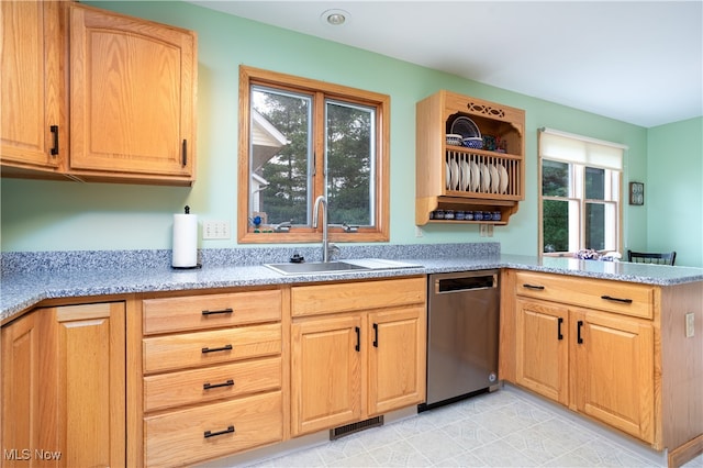 kitchen with dishwasher, kitchen peninsula, sink, light tile patterned flooring, and light stone countertops