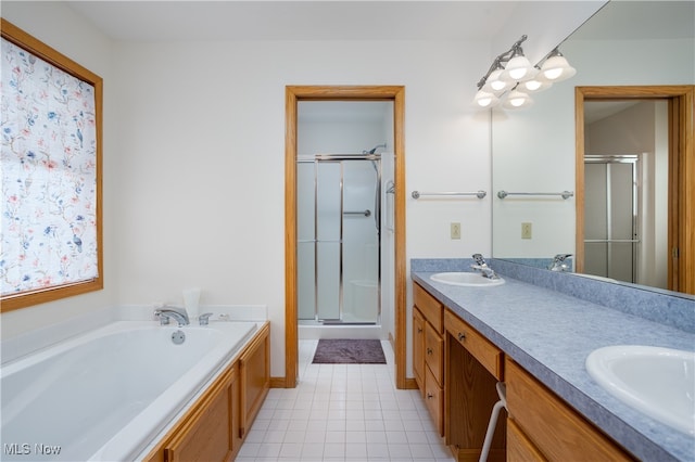 bathroom with vanity, shower with separate bathtub, and tile patterned floors