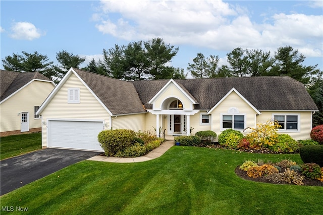 view of front of home with a garage and a front yard