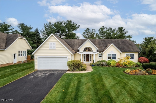 ranch-style home featuring a front lawn and a garage