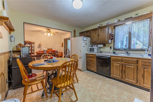 kitchen featuring white appliances, ceiling fan, and sink