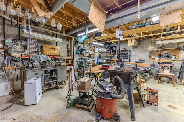 misc room featuring concrete flooring and a workshop area