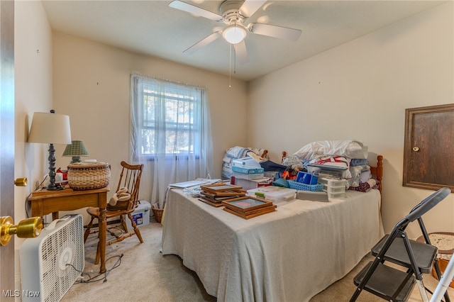 bedroom featuring light carpet and ceiling fan