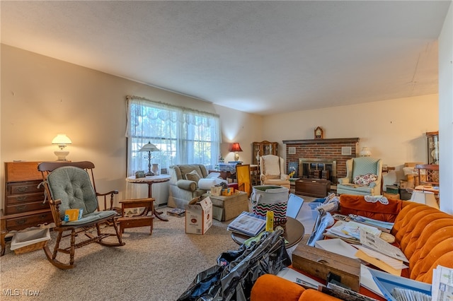 living room featuring a brick fireplace and carpet