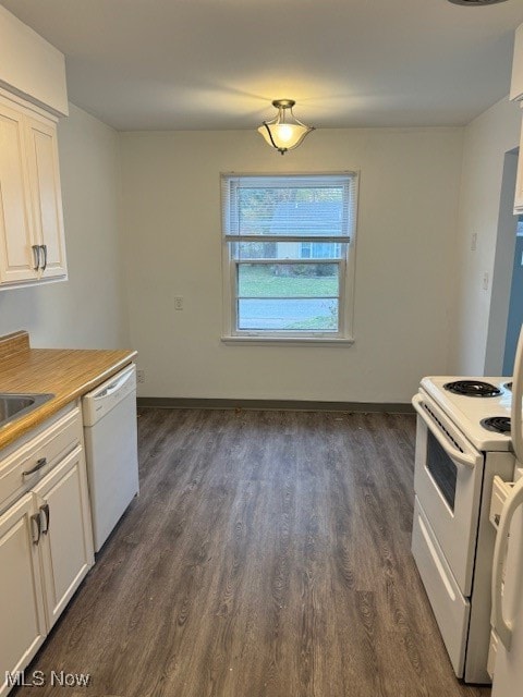 kitchen with dark hardwood / wood-style flooring, white cabinetry, and white appliances