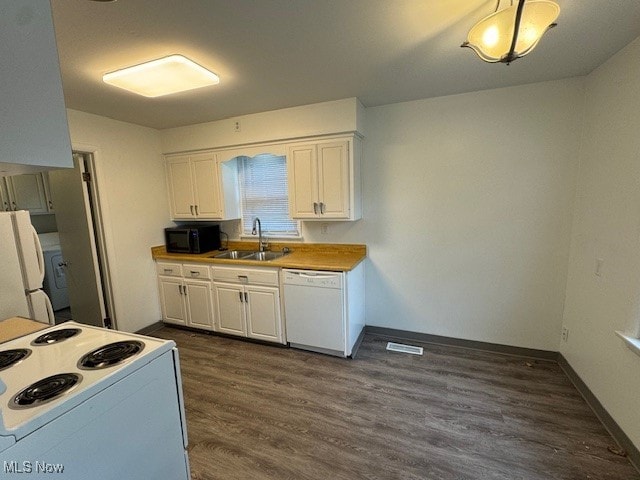 kitchen featuring dark hardwood / wood-style flooring, white cabinetry, white appliances, and sink