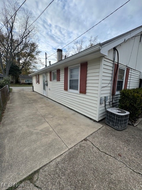 view of property exterior featuring a patio area and cooling unit