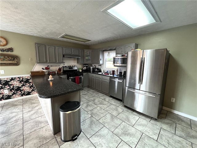 kitchen with stainless steel appliances, gray cabinets, and sink