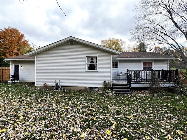 back of house with a yard and a deck