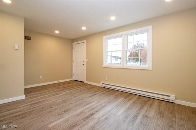 spare room featuring light hardwood / wood-style floors and baseboard heating