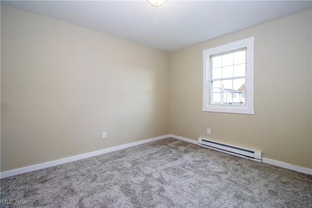 carpeted spare room with a baseboard radiator