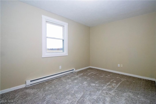 spare room featuring carpet and a baseboard heating unit