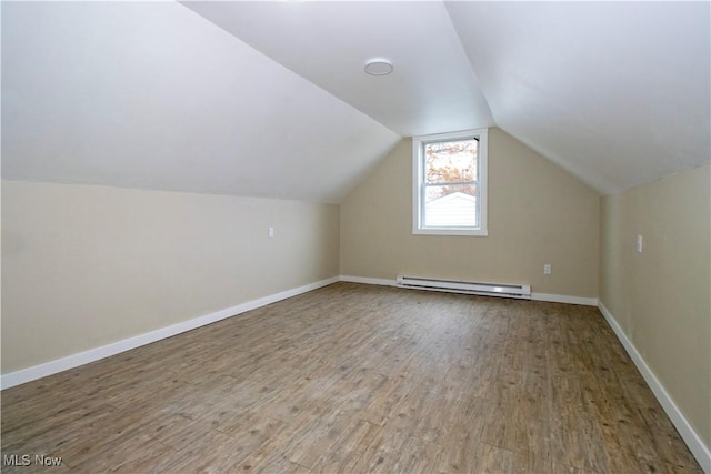 bonus room with wood-type flooring, a baseboard radiator, and lofted ceiling