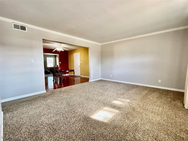 empty room featuring ornamental molding, carpet, and ceiling fan