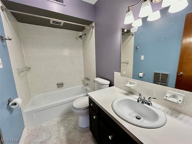 full bathroom featuring tile patterned flooring, vanity, toilet, and tiled shower / bath combo